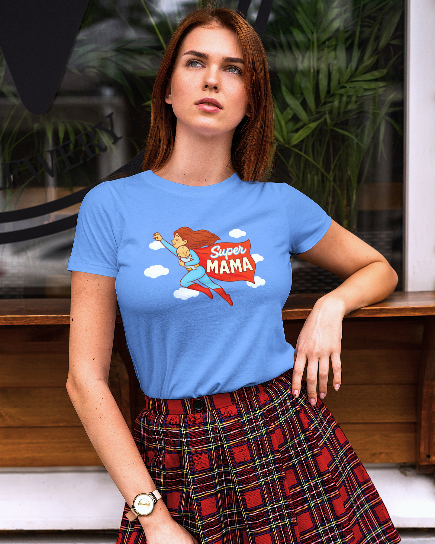 Confident woman in carolina blue superhero mom shirt standing outdoors – bold and empowering shirt for moms
