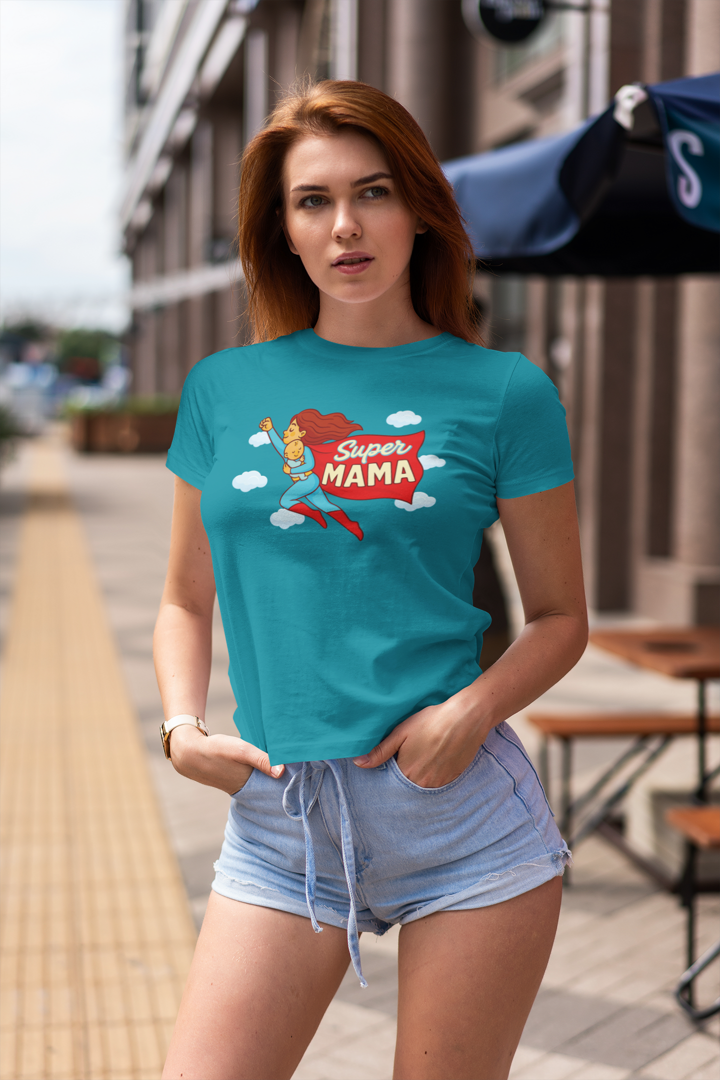 Woman wearing teal mommy superhero shirt outdoors – unique gift idea for first time moms
